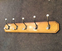5 Brass and Ceramic Coat Hooks on Board