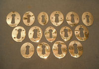 Many Similar Pressed Brass Keyhole Surrounds KC211