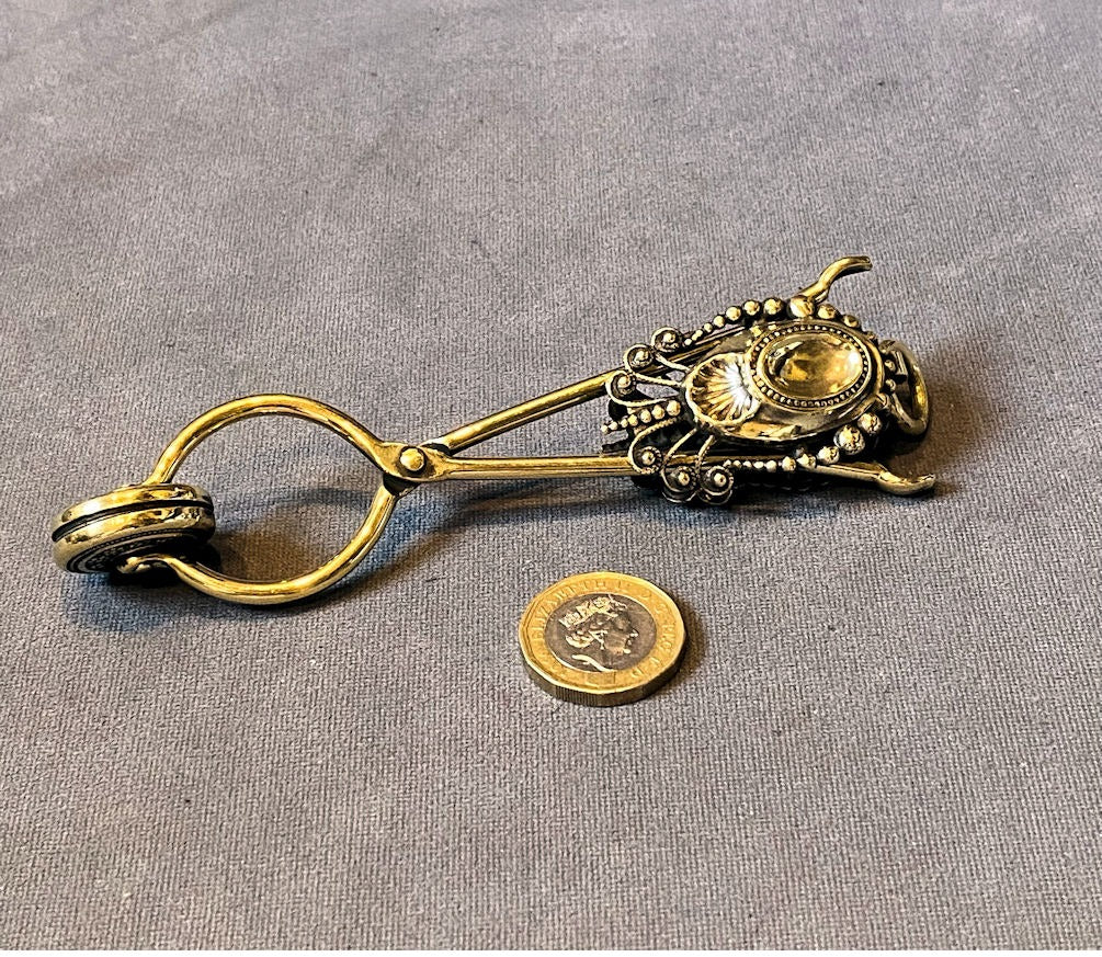 Brass Skirt Lifter — Brass, late 19th century