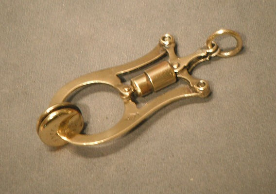 Brass Skirt Lifter — Brass, late 19th century