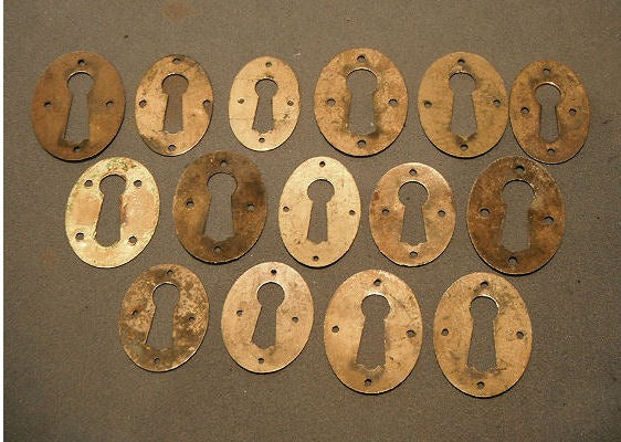 Many Similar Pressed Brass Keyhole Surrounds — view 2