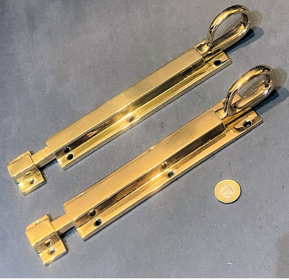 Near Pair of 9 1/8" Brass Door Bolts — Brass, 1920's