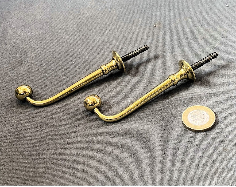 Pair of Brass Hat Hooks — Brass, late 19th century