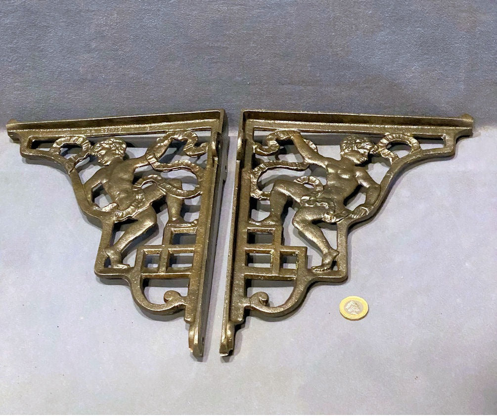 Pair of Figural Cast Iron Wall Brackets — Cast iron, late 19th century